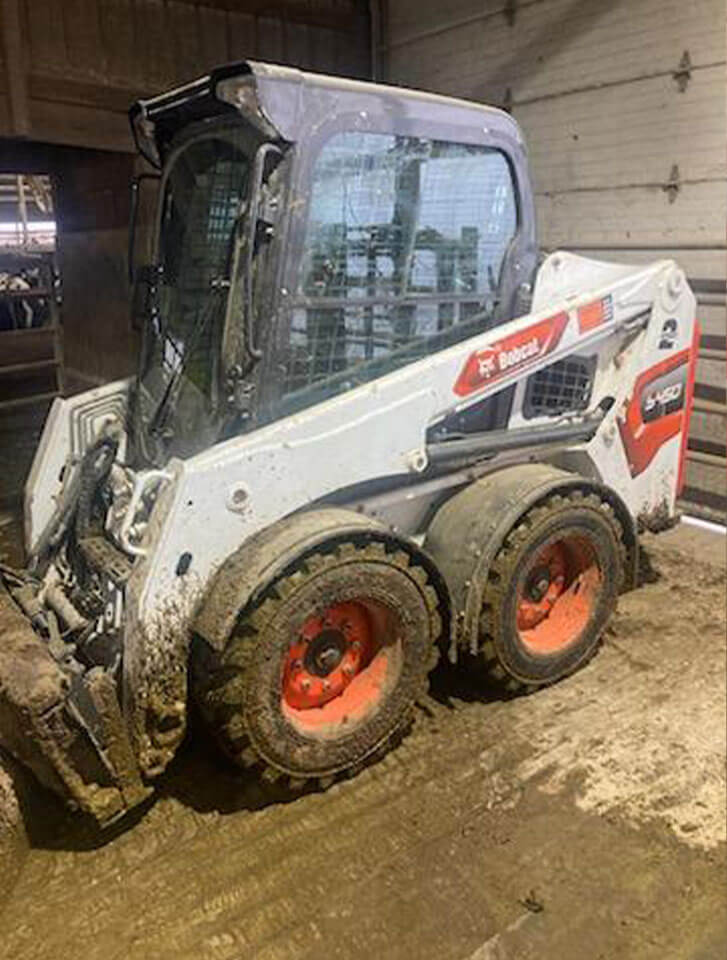 Dirty John Deere Skidloader after used with D-Fenders