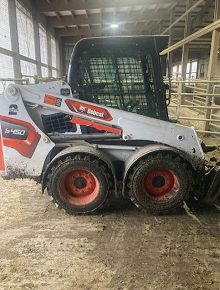 Dirty John Deere Skidloader after used with D-Fenders